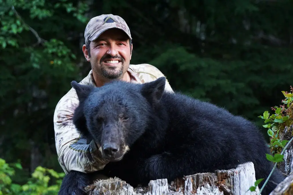 Cory-Glauner Washington black bear OLO 2015 » Outdoors International Cory with his... umm.... we'll just say "huge" Washington black bear.
