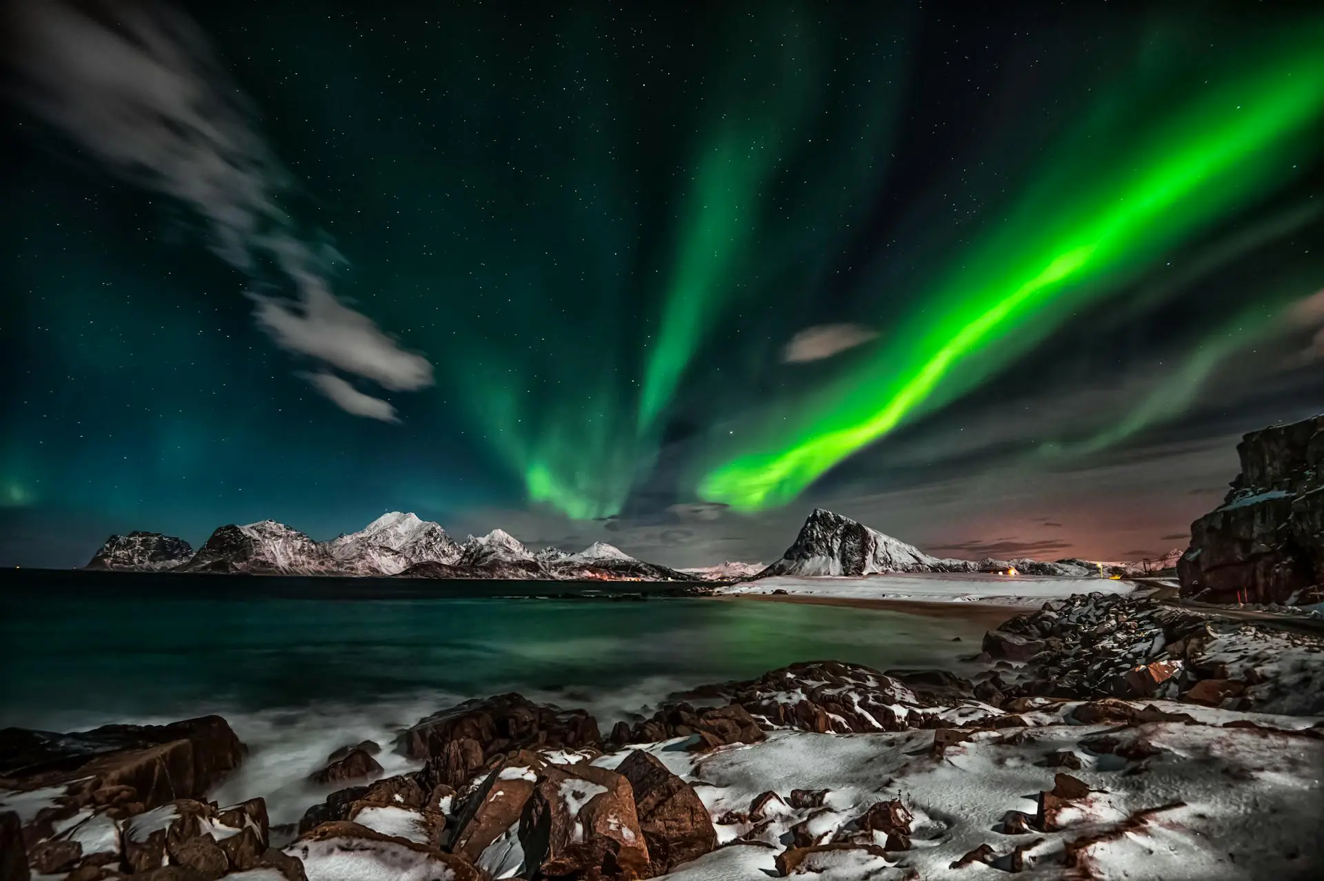 pexels-therato-1933317 » Outdoors International Northern lights over the mountains and ocean in Norway.