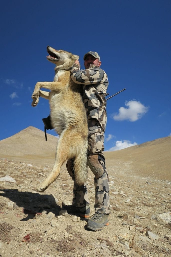 A hunter with a wolf taken in Tajikistan