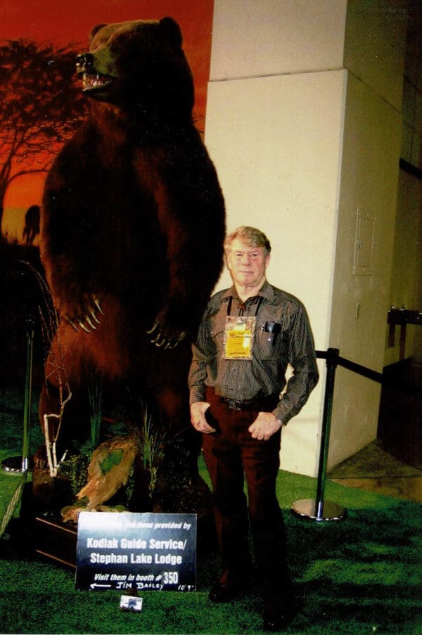 Jim Bailey with a 10′ 9″ brown bear taken by one of his hunters.
