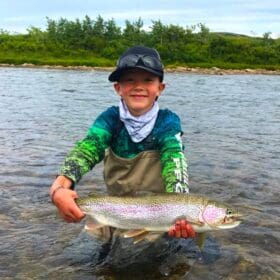 Kid with a nice rainbow trout