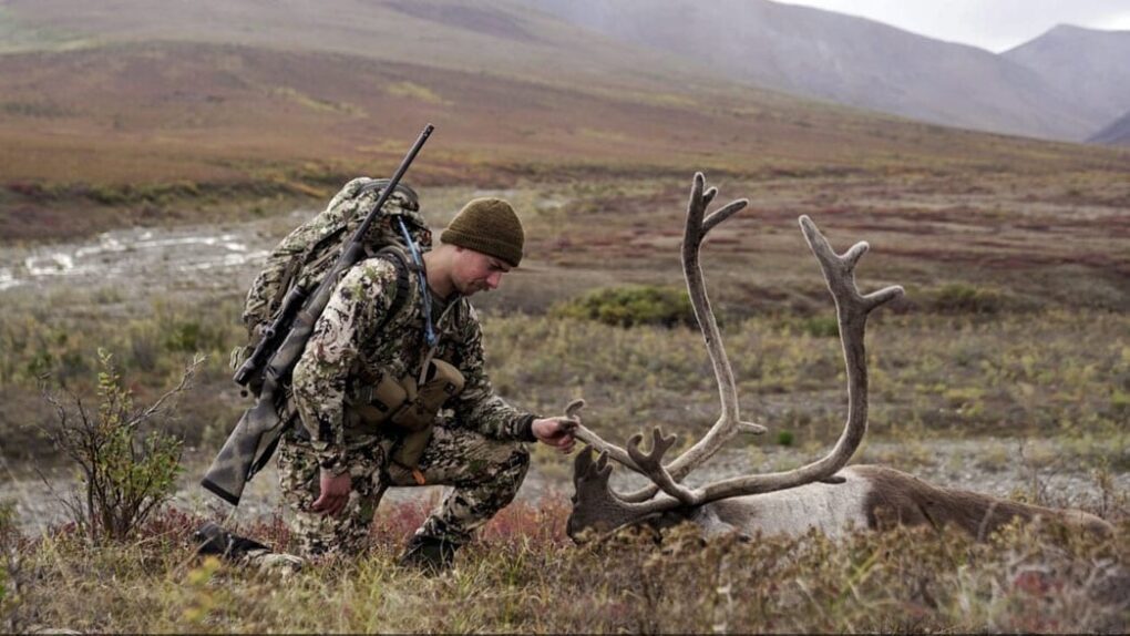 Outdoors International client Beau Martonik with a beautiful caribou bull.