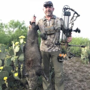 Russ Meyer, co-owner of OUTDOORS INTERNATIONAL with a big archery South Texas Javelina.