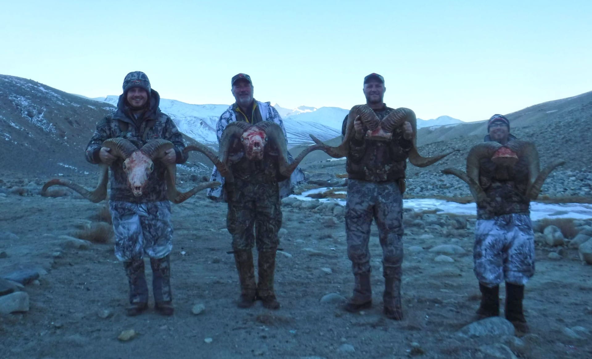 A group of hunters with their rams.