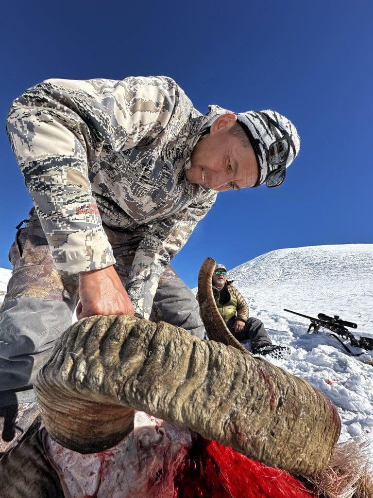 Hunter in Tajikistan caping his Marco Polo ram.