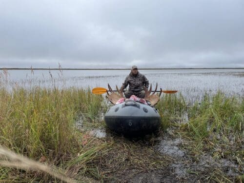 Packing out a bull moose on an inflatable raft