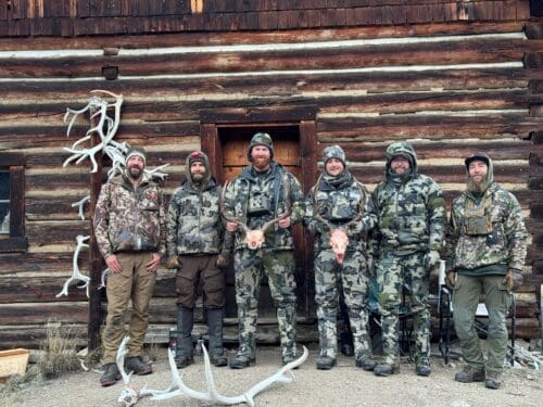 Jared Eyler group with their bucks beside the lodge.