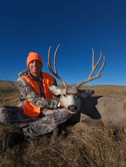 Outdoors International client Caleb Weber with a Montana mule deer.