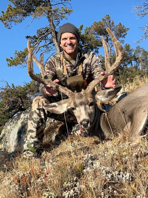Outdoors International Consultant Charlie Ward with a mule deer.