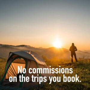 Outfitter enjoying the sunrise outside his tent with a cup of coffee.