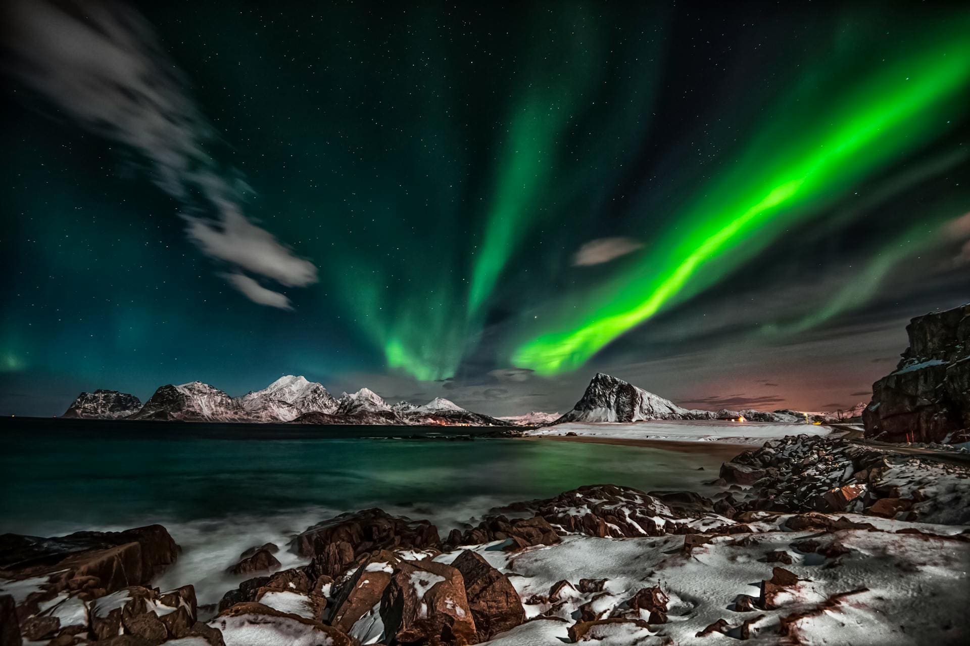 pexels-therato-1933317 » Outdoors International Northern lights over the mountains and ocean in Norway.