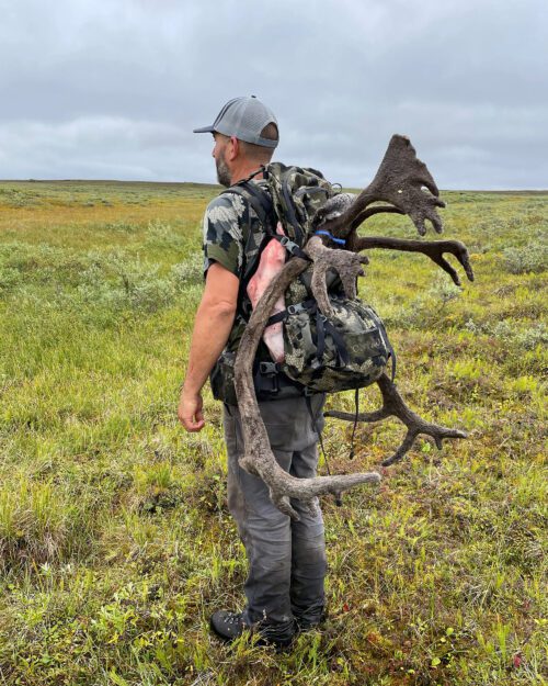 Aaron Jones packing out his caribou.