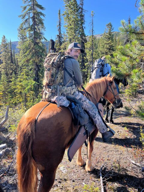 Alex riding a horse into goat hunt.