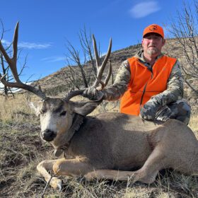 Victor Rossi with his great Colorado mule deer, sporting a radio collar.