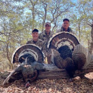 Hunters with two Gould's wild turkeys taken in Sonora, Mexico