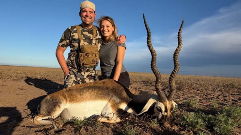 A hunter and his wife with a huge blackbuck