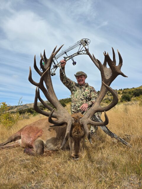 Jim Creigh — massive red stag with compound bow (New Zealand, 2026)