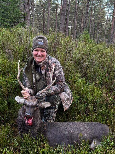 OI Client — female hunter with sika stag in forest (Scotland, 2026)