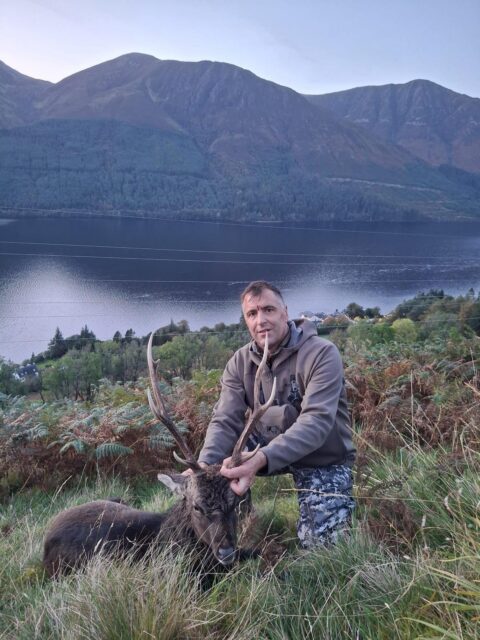 OI Client — red stag hunter Scottish Highlands loch (Scotland, 2026)