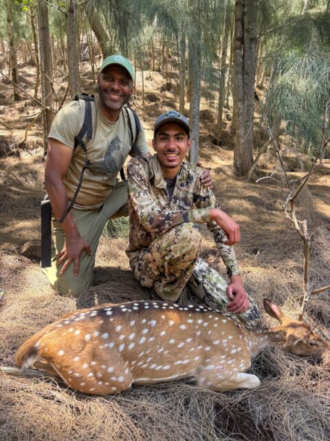 Omari Bunn — spotted fallow deer with hunter and guide in forest (Hawaii, 2026)