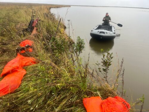 Rex Skiles — hunter paddling inflatable boat on tundra river (Alaska, 2026)